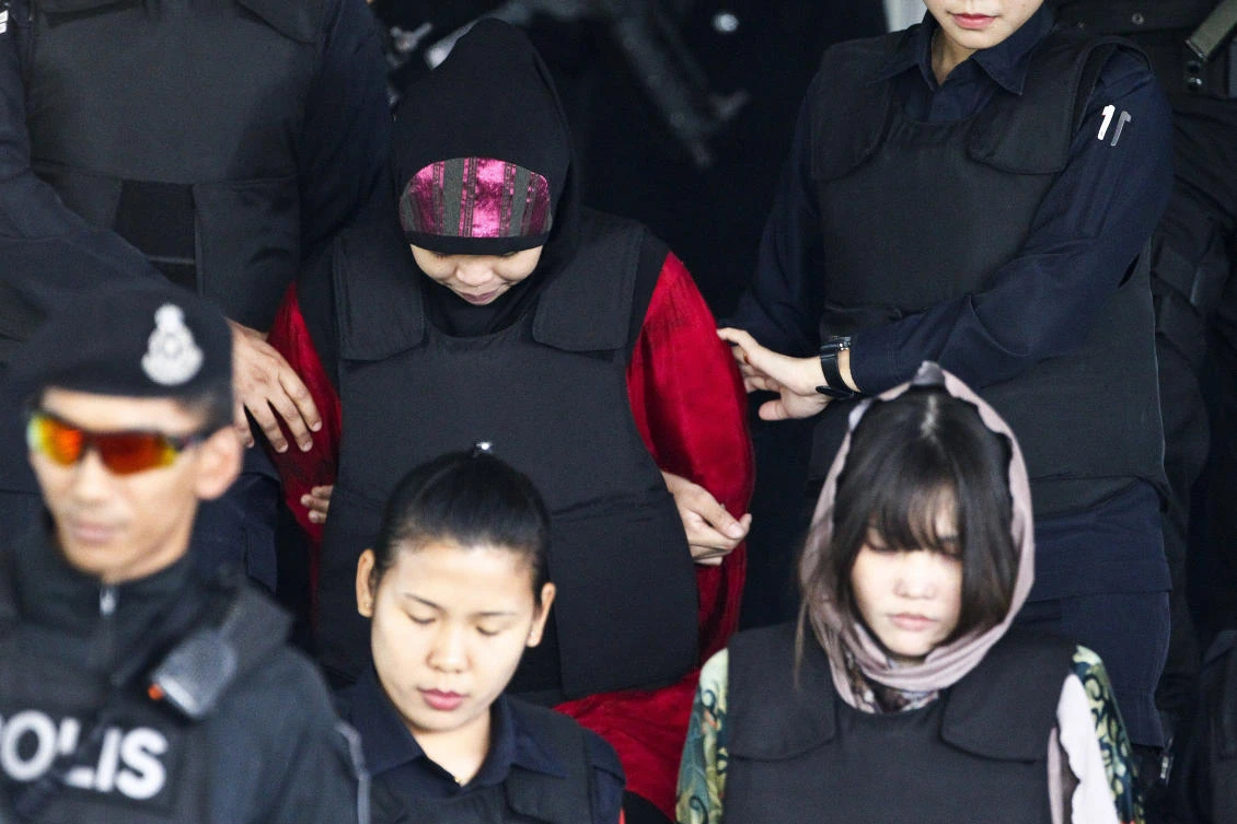 Indonesian Siti Aisyah, top left, and Vietnamese Doan Thi Huong, bottom right, escorted by police as they leave after a court hearing at Shah Alam High Court in Shah Alam, Malaysia, Thursday, April 5, 2018. Doan and Aisyah have pleaded have pleaded not guilty of killing Kim Jong Nam, the estranged brother of North Korean leader Kim Jong Un, on Feb. 13, 2017, at a crowded Kuala Lumpur airport terminal. (AP/Sadiq Asyraf)