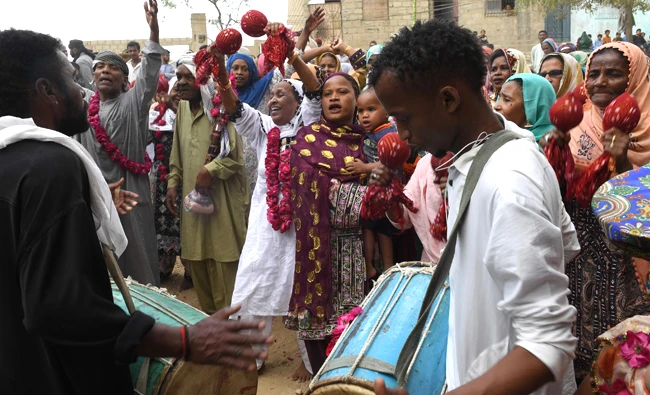 In this file photo, Pakistani devotees of the Sheedi ethnic group play traditional music at the shrine of Sufi Hasan-al-Maroof Sultan Manghopir, during the Sheedi Mela or crocodiles festival, on the outskirts of Karachi. (AFP)