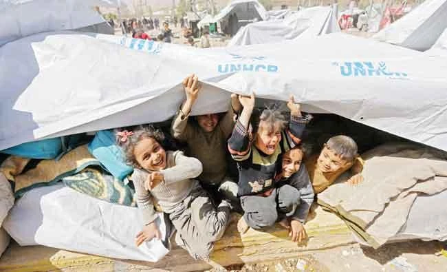 Syrian children, evacuated from Eastern Ghouta, play at a shelter in the regime-controlled Adra district, on the northeastern outskirts of Damascus. AFP