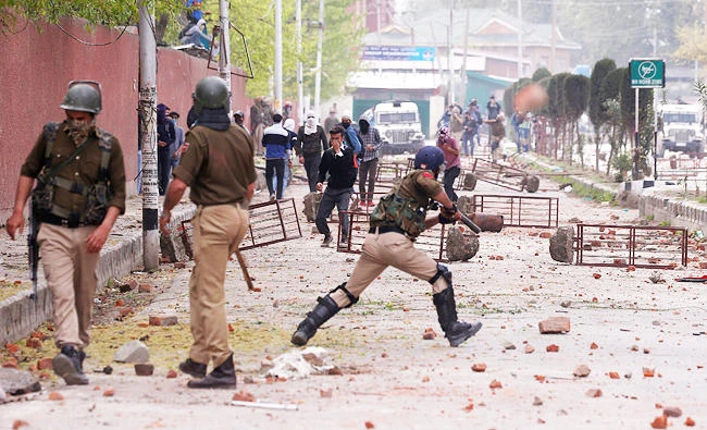 Students hurl stones towards Indian police during a protest against the recent killings in Kashmir, outside a college in Srinagar, in this April 5, 2018 photo. (REUTERS)