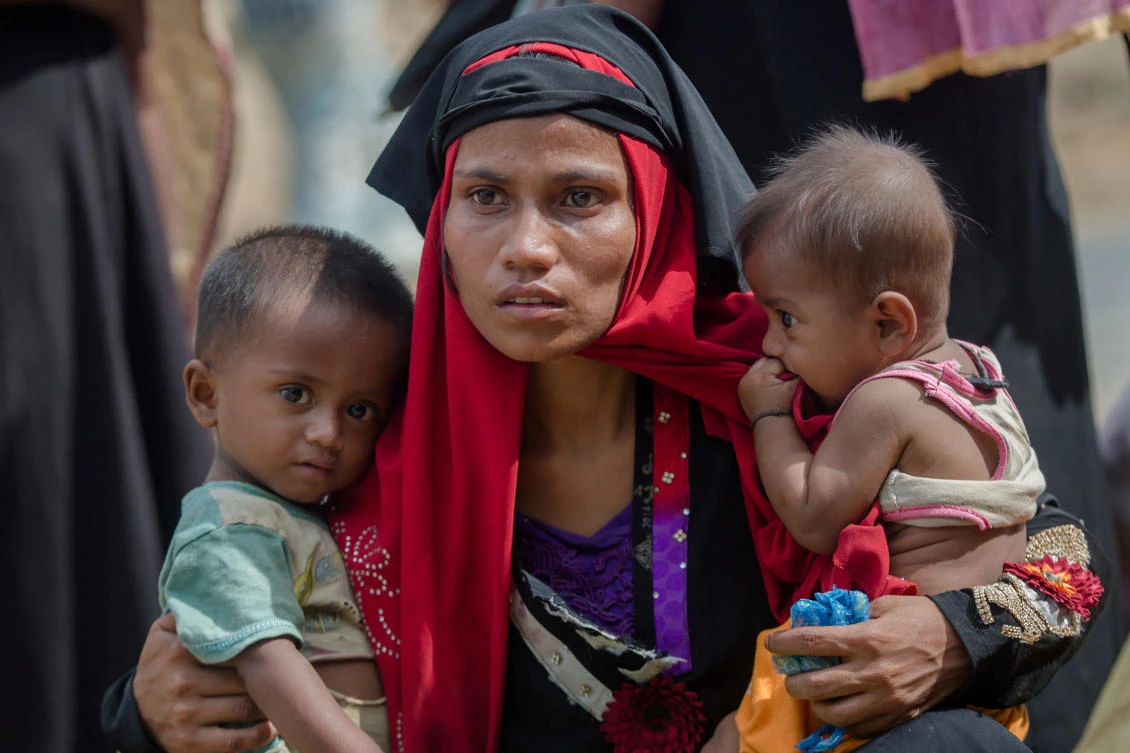 Rohingya Muslim woman, Rukaya Begum, who crossed over from Myanmar into Bangladesh, holds her son Mahbubur Rehman, left and her daughter Rehana Bibi, after the government moved them to newly allocated refugee camp areas, near Kutupalong, Bangladesh. (AP)