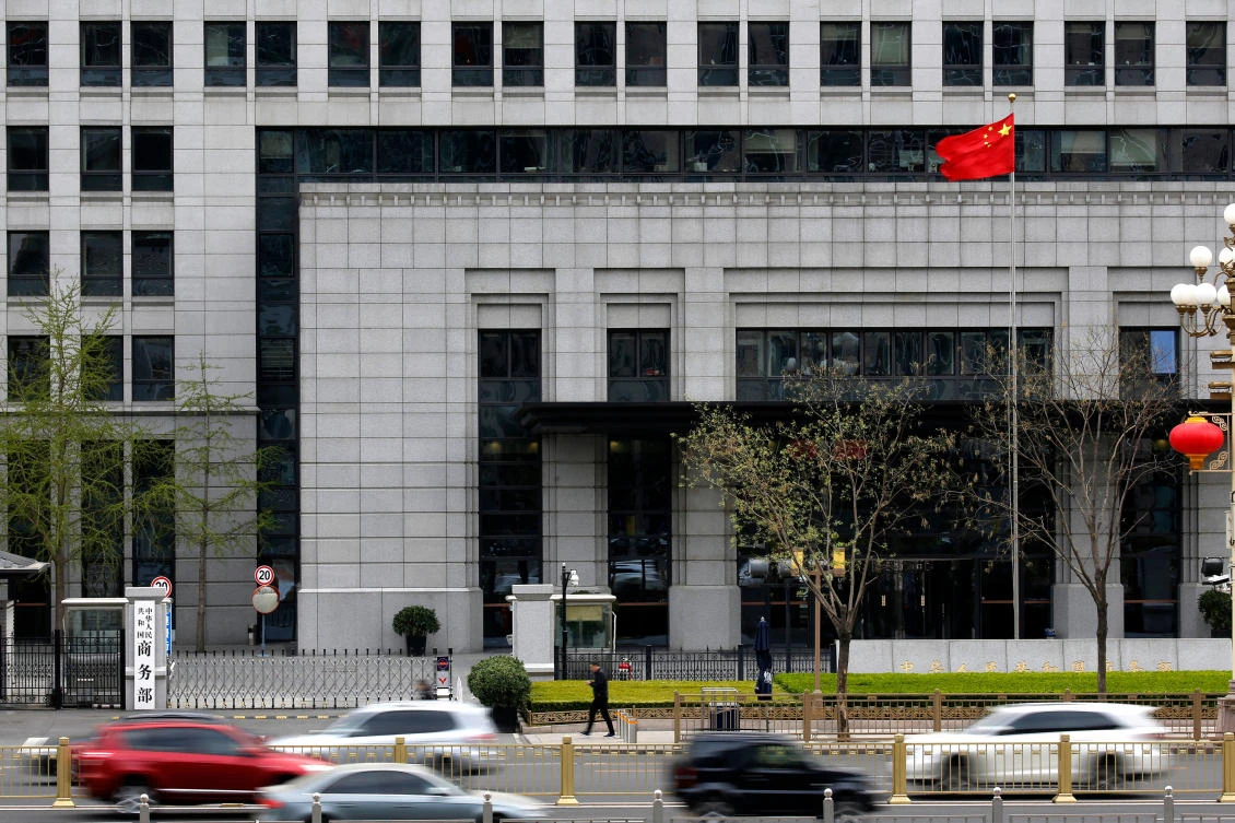 Motorists drive past the China’s Ministry of Commerce in Beijing, Friday, April 6, 2018. China vowed on Friday to fight the US “at any cost” after President Donald Trump proposed slapping an additional $100 billion in tariffs on Chinese goods in an escalating trade dispute between the world’s two largest economies. (AP/Andy Wong)