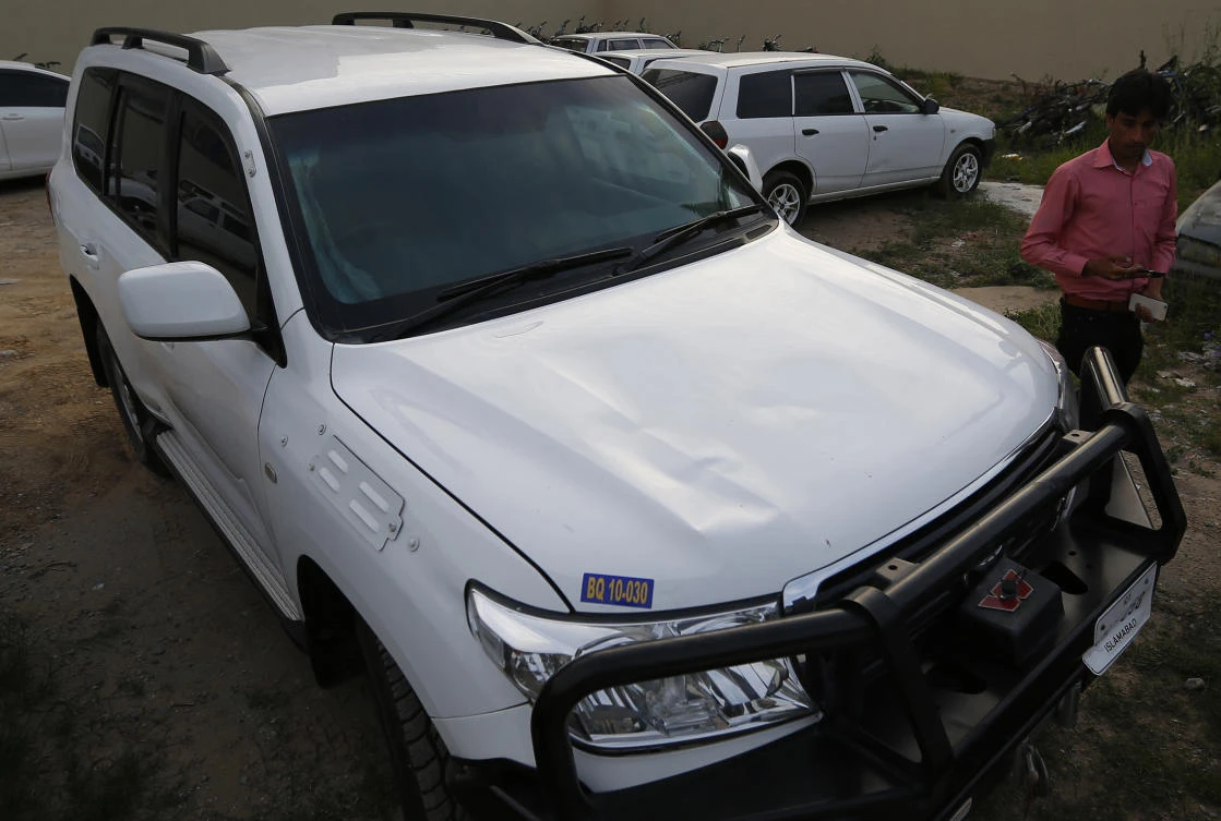 A Pakistani journalist examines a car of American diplomate parked inside a police station after an accident in Islamabad, Pakistan, Saturday, April 7, 2018. Pakistani police say a car carrying an American diplomat has accidentally hit a Pakistani motorcyclist in the capital, Islamabad, killing him on the spot. (AP/Anjum Naveed)