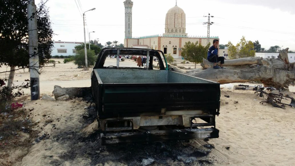 A burned truck is seen outside Al-Rawda Mosque in Bir al-Abd northern Sinai, Egypt a day after attackers killed hundreds of worshippers. (AFP)