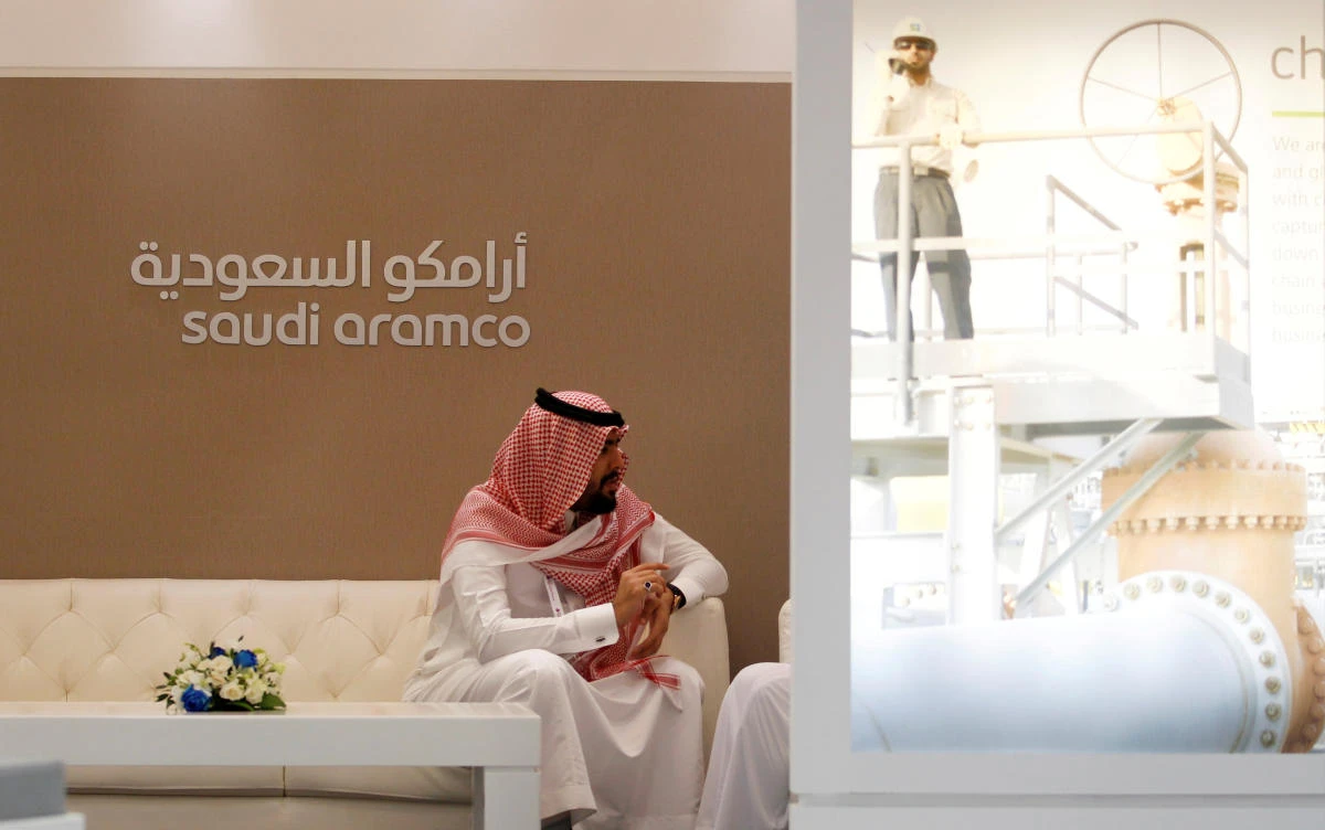 A Saudi Aramco employee sits in the area of its stand at the Middle East Petrotech 2016, an exhibition and conference for the refining and petrochemical industries, in Manama, Bahrain, September 27, 2016. (Reuters)