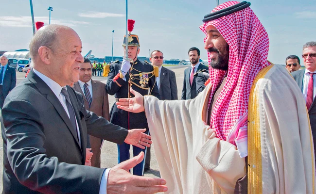 French Foreign Affairs Minister Jean-Yves Le Drian welcomes Saudi Arabia’s Crown Prince Mohammed bin Salman at Paris-Le Bourget airport on Sunday. AFP