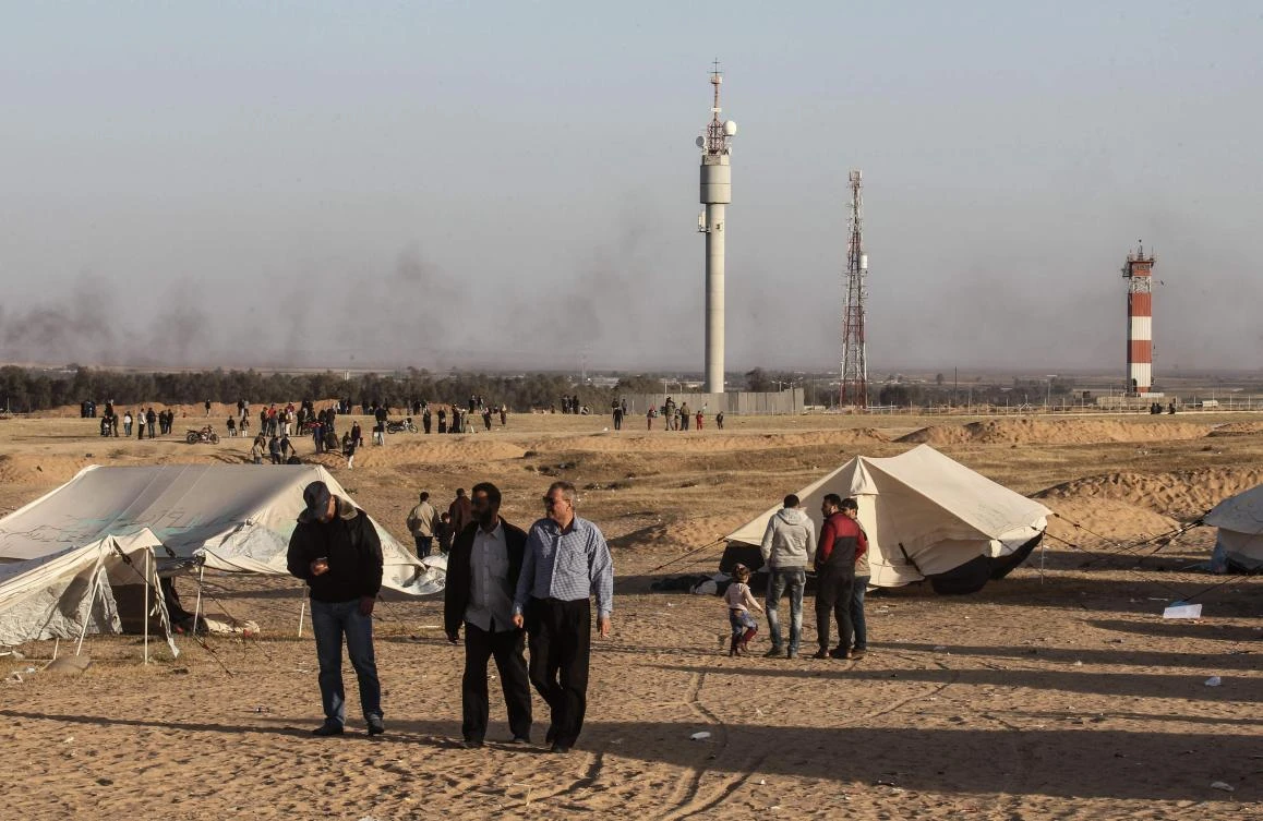 Palestinians gather at the site of a tent protest on the Israel-Gaza border east of Rafah in the southern Gaza Strip. The border fence between the Palestinian enclave and Israel has become the backdrop of mass Gaza demonstrations that lead to deadly clashes. (AFP)