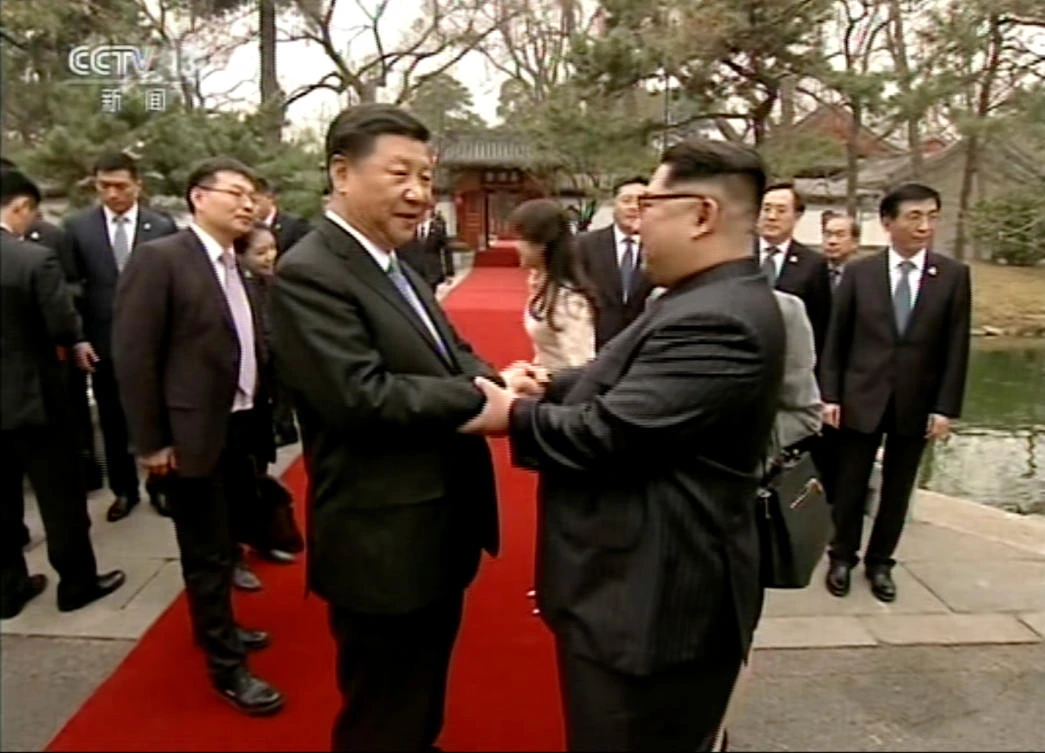 North Korean leader Kim Jong Un, right, and Chinese counterpart Xi Jinping shake hands at Diaoyutai State Guesthouse in Beijing in this video grab by state broadcaster CCTV. Beijing was long Pyongyang’s diplomatic protector but has supported the UN sanctions out of frustration at what Chinese leaders see as their neighbor’s increasingly reckless behavior. (AP)