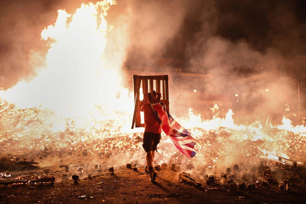A Nothern Ireland loyalist at a bonfire in Belfast’s Sandy Row area. Loyalist paramilitary groups said they would no longer be ‘apologists for conflict’ but ‘advocates for change.’ (Getty Images)