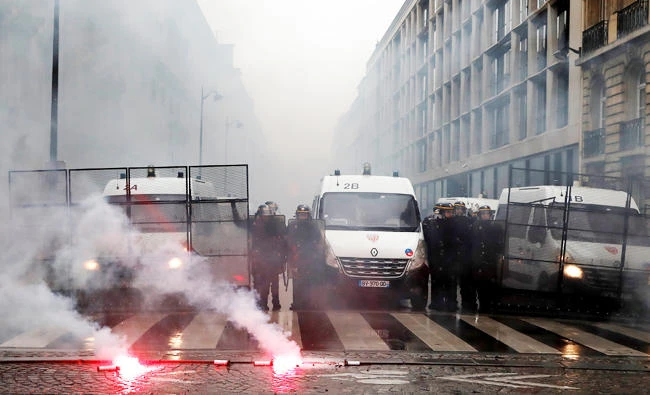 French CRS riot police face off with protestors during a demonstration by French state-owned railway company SNCF workers and CGT labour union members in Paris as part of a nationwide strike in France, on Monday. (REUTERS)