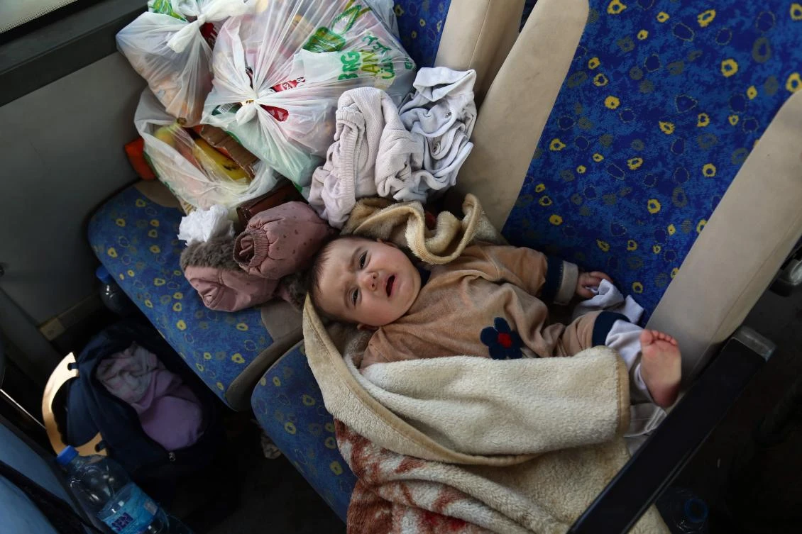 Buses carrying families of Jaish al-Islam fighters, from the former rebel bastion's main town of Douma, arrive at the Abu al-Zindeen checkpoint controlled by Turkish-backed rebel fighters near the northern Syrian town of al-Bab, on April 5, 2018. (AFP)