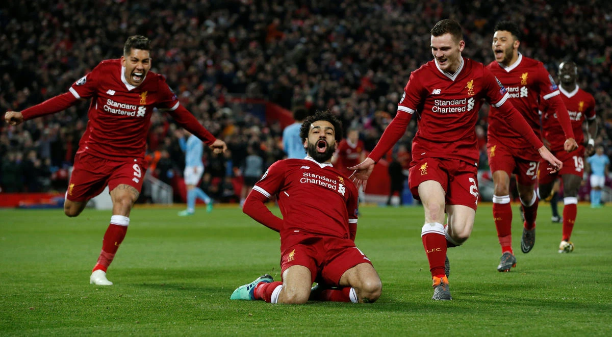 Liverpool's Mohamed Salah celebrates with Roberto Firmino and Andrew Robertson scoring their first goal. (REUTERS)
