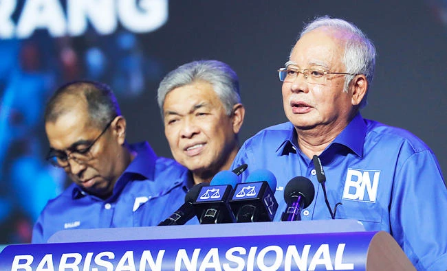 In this April 7, 2018 photo, Malaysia's Prime Minister and President of the ruling party coalition "National Front", Najib Razak, right, speaks to party supporters during launching event for upcoming general elections in Kuala Lumpur, Malaysia. (AP)