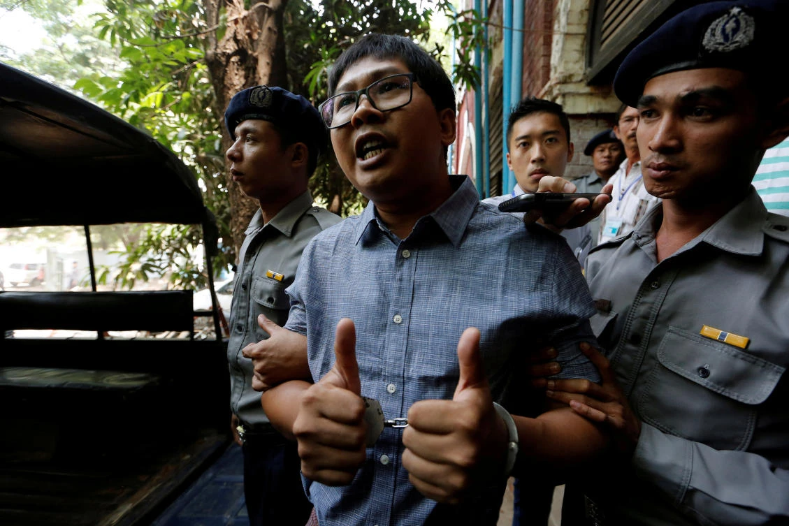 Detained Reuters journalist Wa Lone is escorted by police after a court hearing in Yangon on April 4. A Myanmar court is pushing ahead with hearings that have sparked global outrage and fears of shrinking press freedoms. (Reuters)