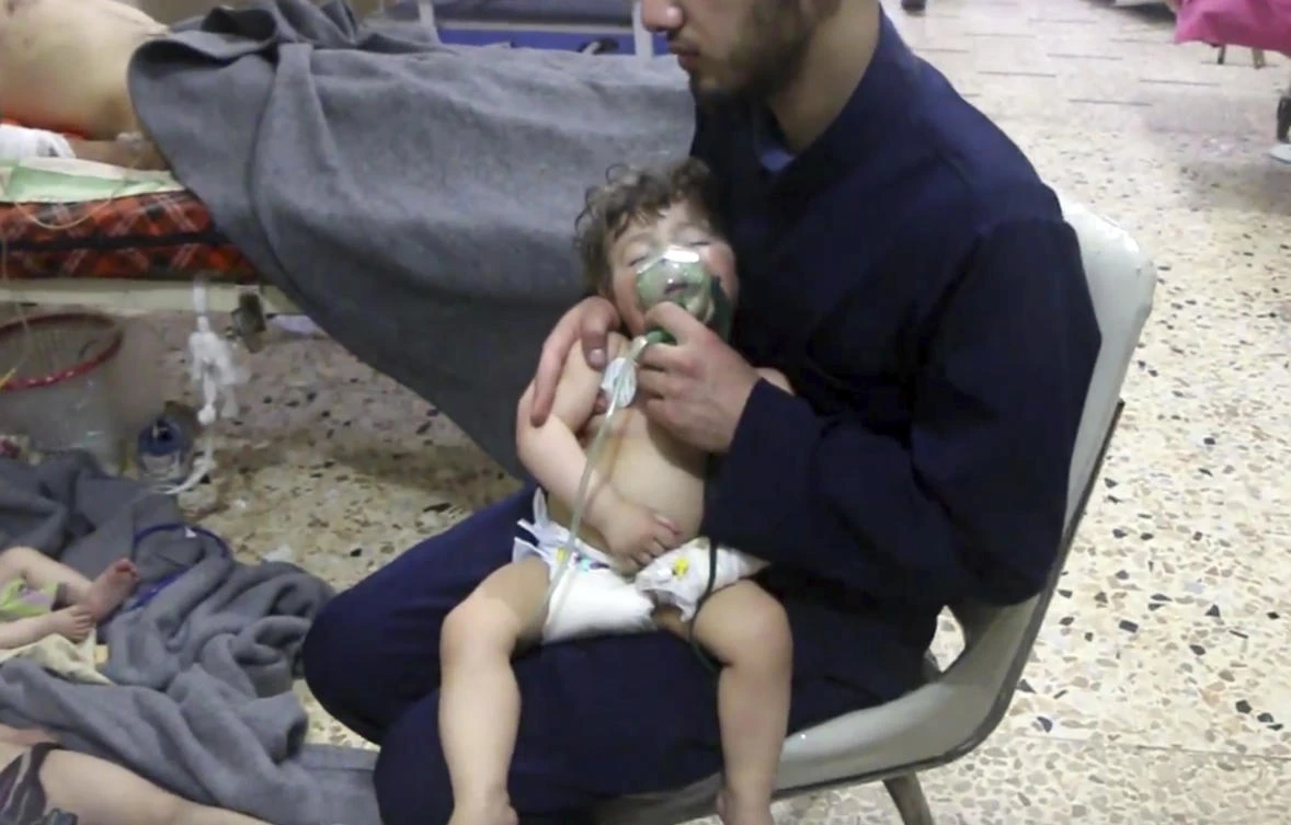 This image made from video released by the Syrian Civil Defense White Helmets, which has been authenticated based on its contents and other AP reporting, shows a medical worker giving toddlers oxygen through respirators following an alleged poison gas attack in the opposition-held town of Douma, in eastern Ghouta, near Damascus, Syria, Sunday, April 8, 2018. (AP)