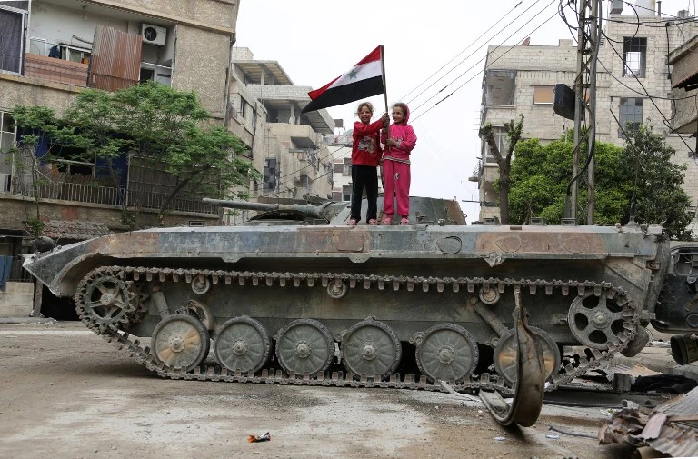 Syrian regime flag raised in Douma, rebels surrender heavy arms in Ghouta