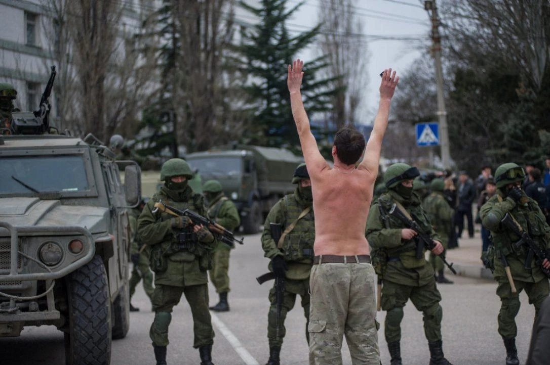 A shirtless Ukrainian protests to Russian troops as they enter Balaklava, in the Crimea. (AP Photo)