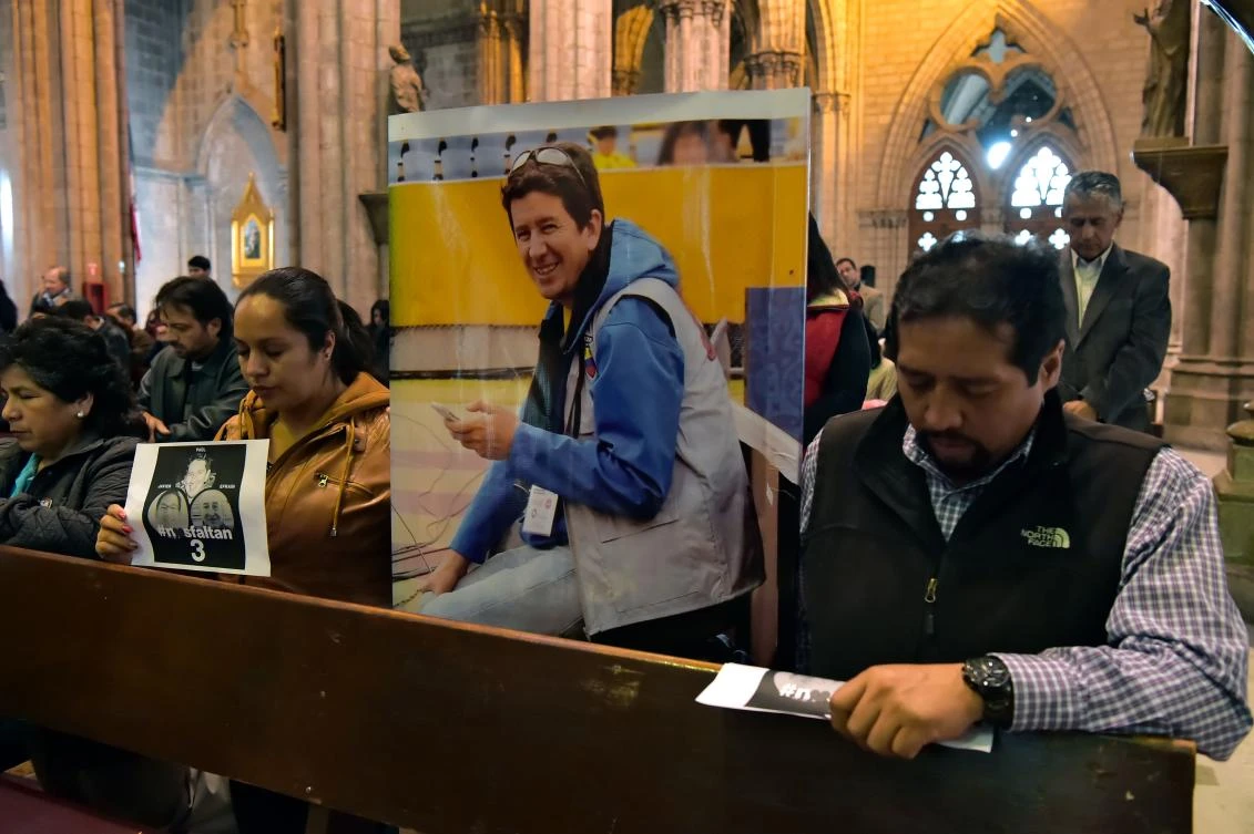 Relatives and friends of journalist Javier Ortega, photographer Paul Rivas and their driver Efrain Segarra, who were abducted by dissident Colombian rebels on the troubled border with Colombia last March 26, take part in a mass at the Basilica of Quito on April 5, 2018. (AFP)