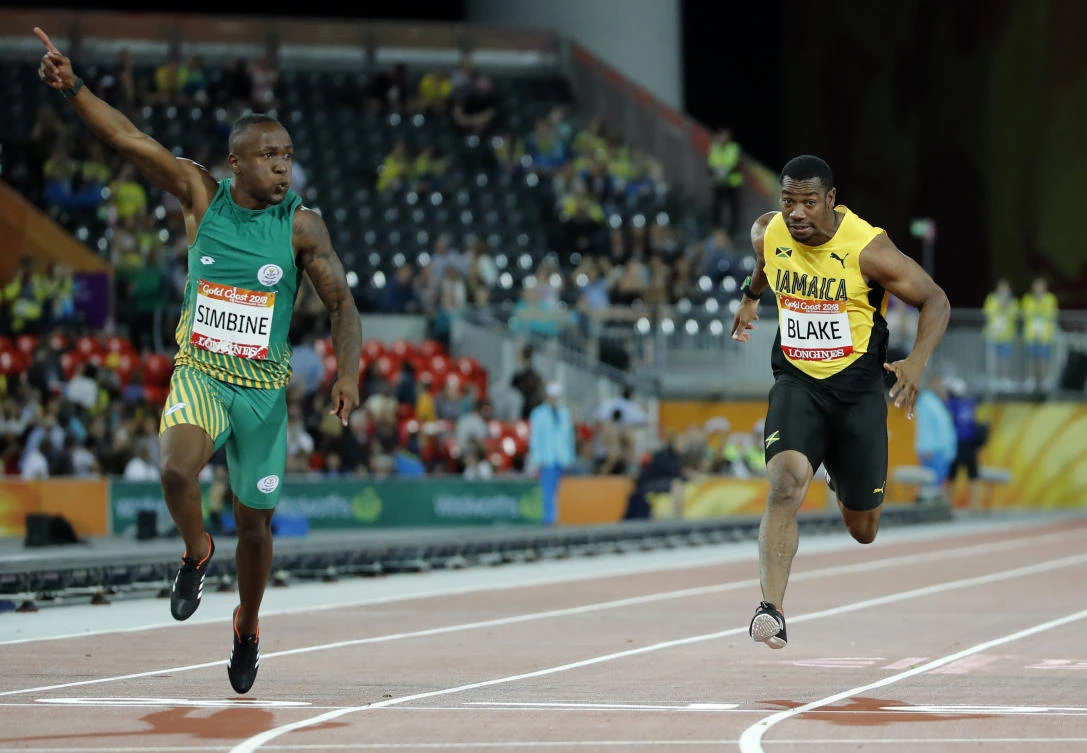South Africa's Akani Simbine, L, celebrates after winning the men's 100m final. Yohan Blake,R, finished third. (AP)