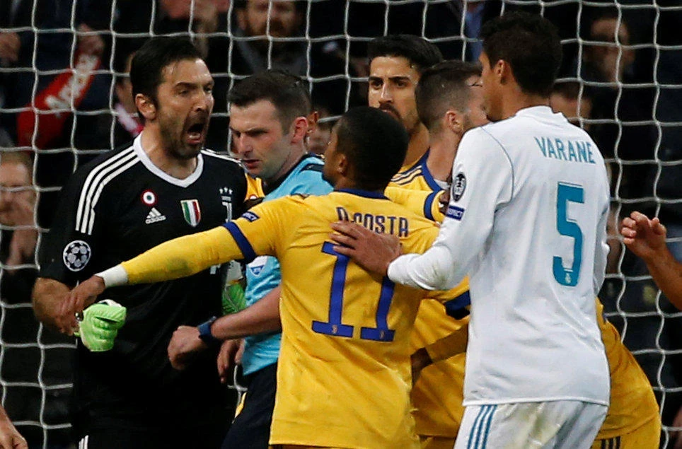 Juventus' Gianluigi Buffon and Douglas Costa lead the protests after Michael Oliver awarded the 12-times champions a controversial penalty in added-on time. (Reuters)