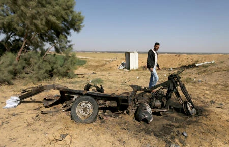 A Palestinian man looks at the scene of an explosion in the southern Gaza Strip April 14, 2018. (Reuters)