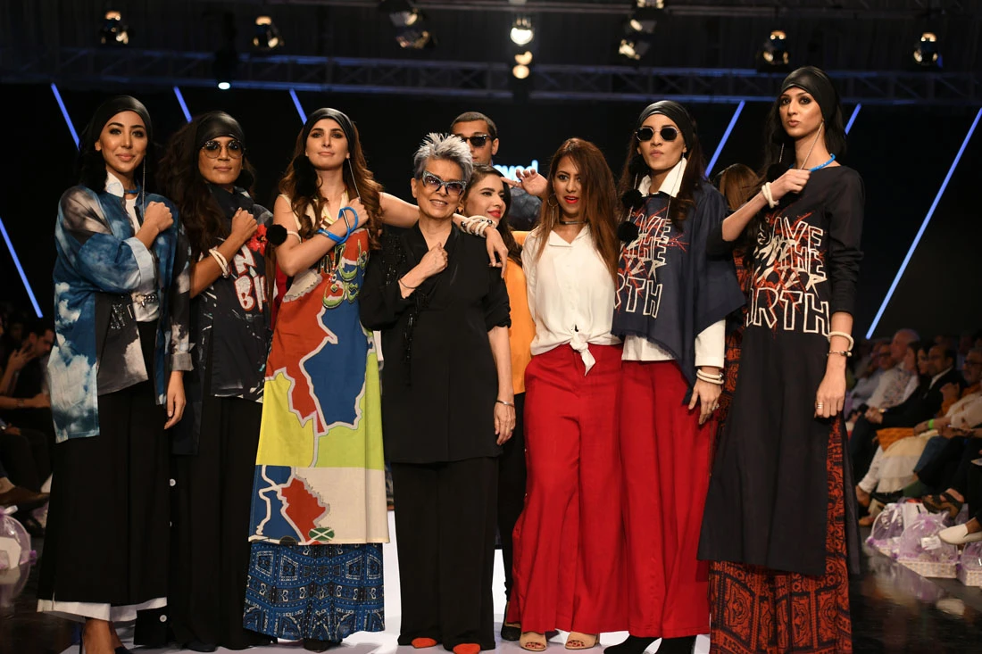 Designer Maheen Khan of Gulabo with her team and models following her show on the first night of Fashion Pakistan Week Spring/Summer 2018, which featured a message of liberation and environmental awareness. (AN