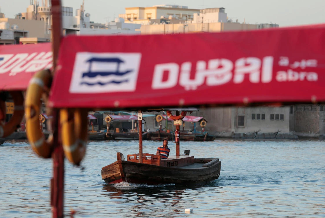 A man drives a water taxi, known as an "Abra" along the creek in old Dubai. The emirate announced new plans to drum up business in the emirate, help retailers and boost trade.