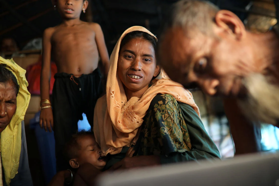 Hasina Khatun, 35, whose husband Dil Mohammed was among 10 Rohingya men killed by Myanmar security forces and Buddhist villagers on September 2, 2017, reacts after seeing a picture of her lost husband at Balukhali camp in Cox’s Bazar, Bangladesh, March 21, 2018. (Reuters)