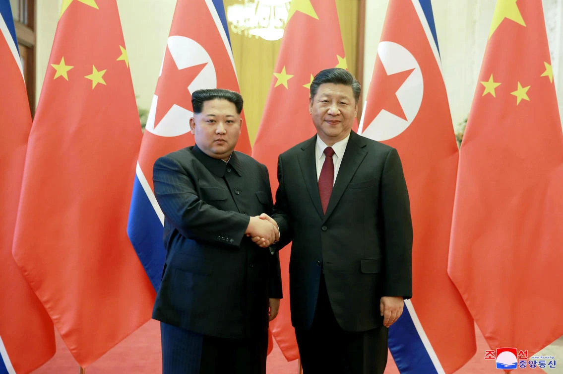 FINorth Korean leader Kim Jong Un, left, and Chinese counterpart Xi Jinping, shake hands at the Great Hall of the People in Beijing. (AP)