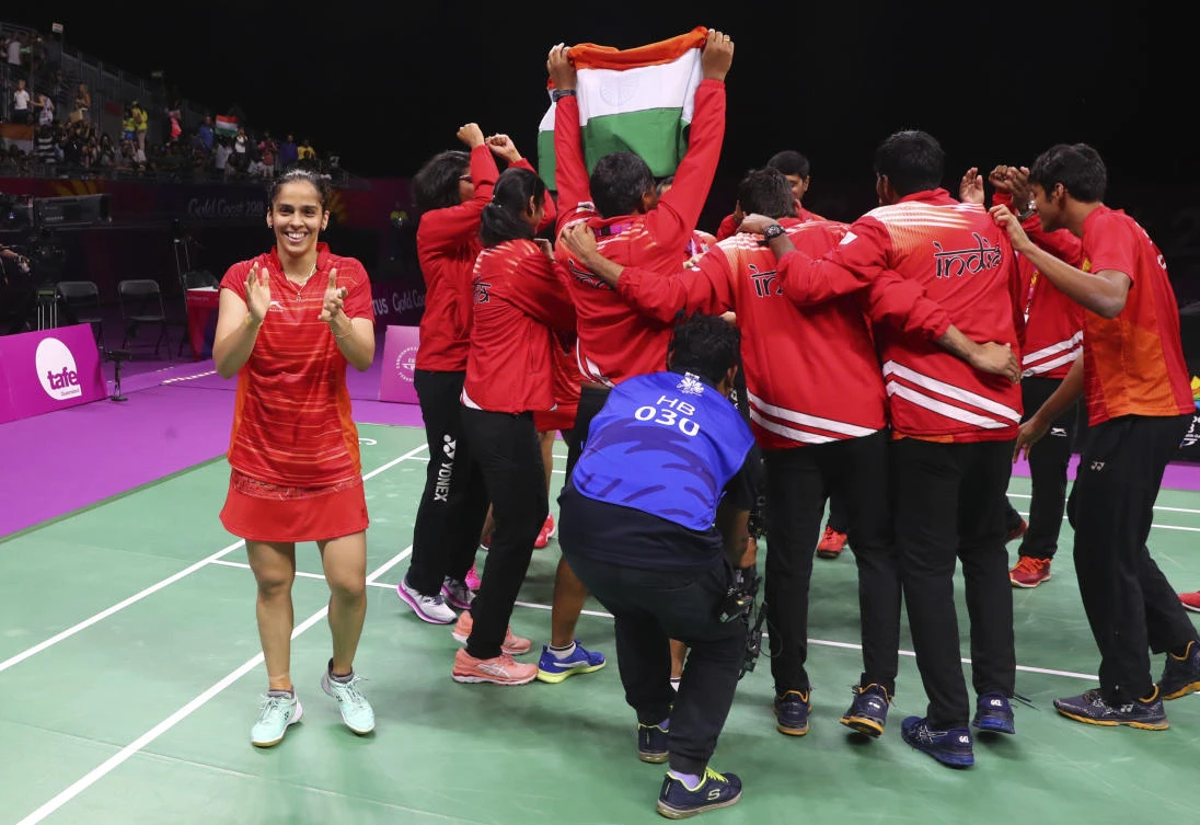 Saina Nehwal, L, and other teammates celebrate soon after wining their match against Malaysia to win gold medal in mixed team event at the Commonwealth Games. (AP)
