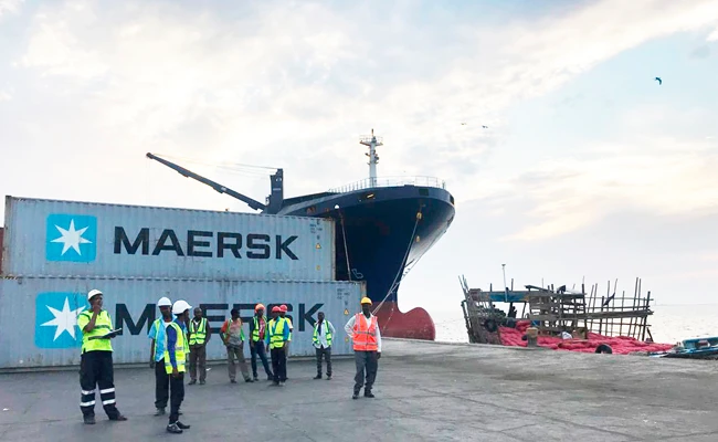 In this April 1, 2018 photo, workers stand in front of shipping containers at the Port of Berbera, run by DP World, which is majority-owned by the Dubai government in the UAE, in Berbera, Somaliland, Somalia. (AP Photo/Malak Harb)