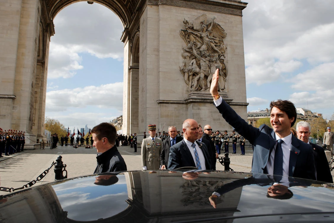 Canadian Prime Minister Justin Trudeau waves to onlookers following a wreath laying ceremony at the Tomb of the Unknown Soldier, at the Arc de Triomphe, in Paris. (Reuters)