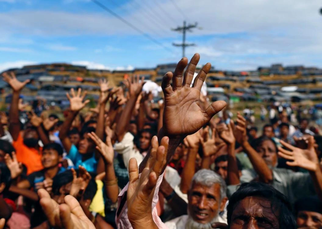 Rohingya refugees stretch out their hands to receive food aid at Balukhali refugee camp in Cox’s Bazar, Bangladesh. There are around 800,000 Rohingya now living in camps in Bangladesh. (Reuters)
