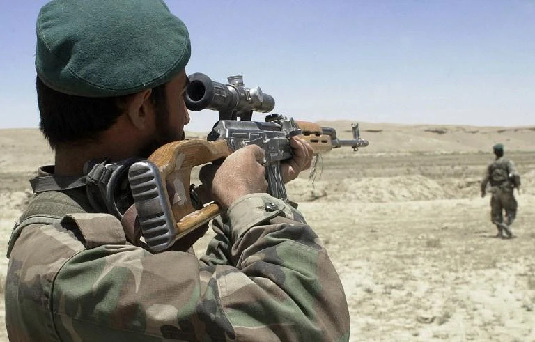 An Afghan soldier covers a member of his team during a patrol in Chaghcharan, the capital of mountainous Ghor province in this 2004 photo. (AFP)