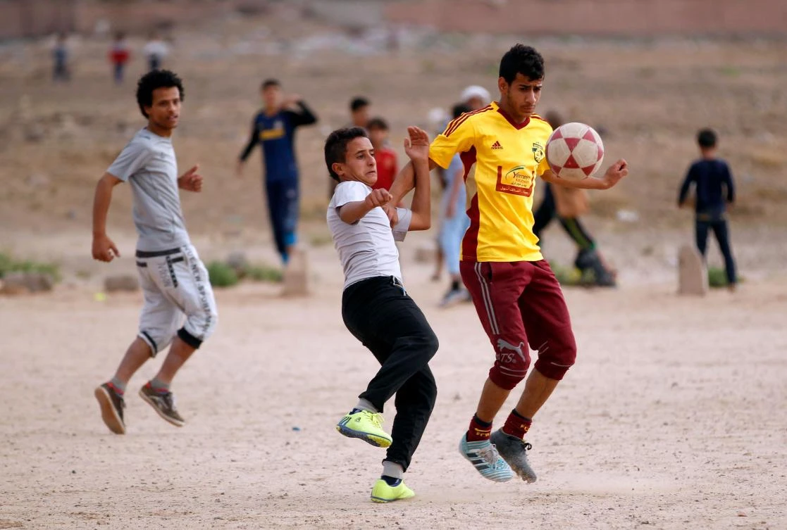 Yemeni youth take part in a football match in their neighborhood in the capital Sanaa. (AFP)