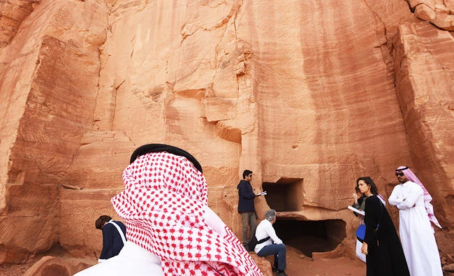 A photo taken on March 31, 2018 shows a Saudi man standing at the entrance of a tomb at Madain Saleh, a UNESCO World Heritage site, near Saudi Arabia's northwestern town of al-Ula. (AFP)