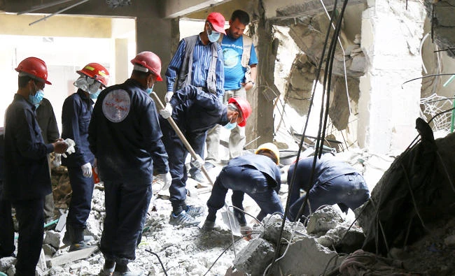 Rescue workers search for bodies still trapped under mounds of debris in Raqqa, Syria, in this April 9, 2018 photo. (REUTERS)