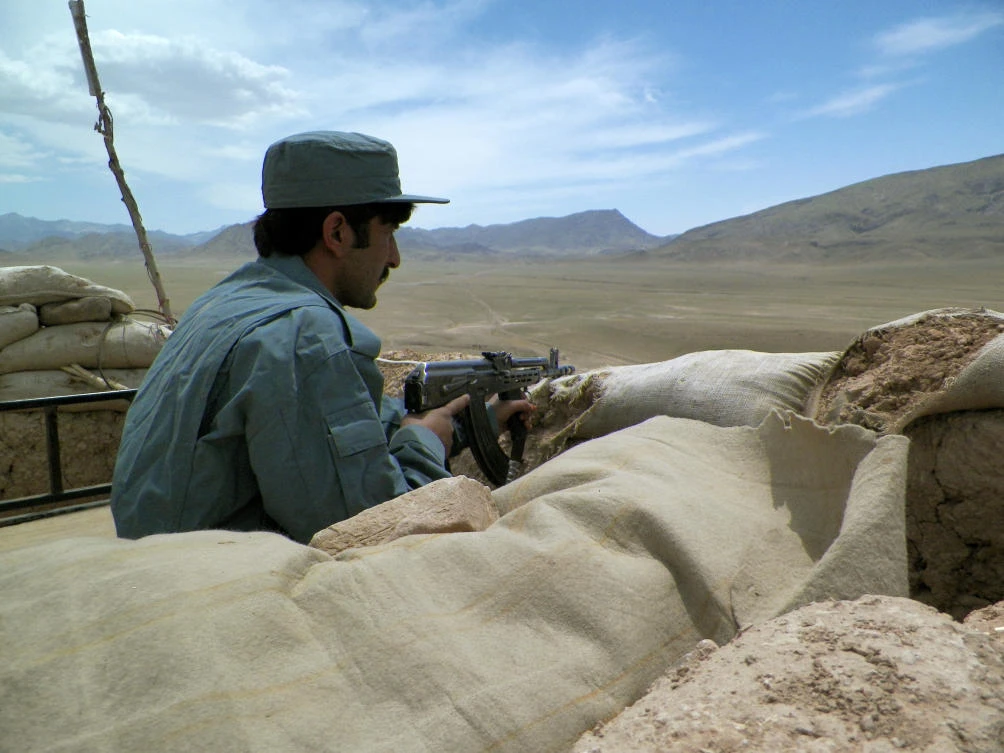 An Afghan policeman keeps watch at a police checkpoint on the Kandahar-Tarin Kot highway: (Rateb Noori/AFP)