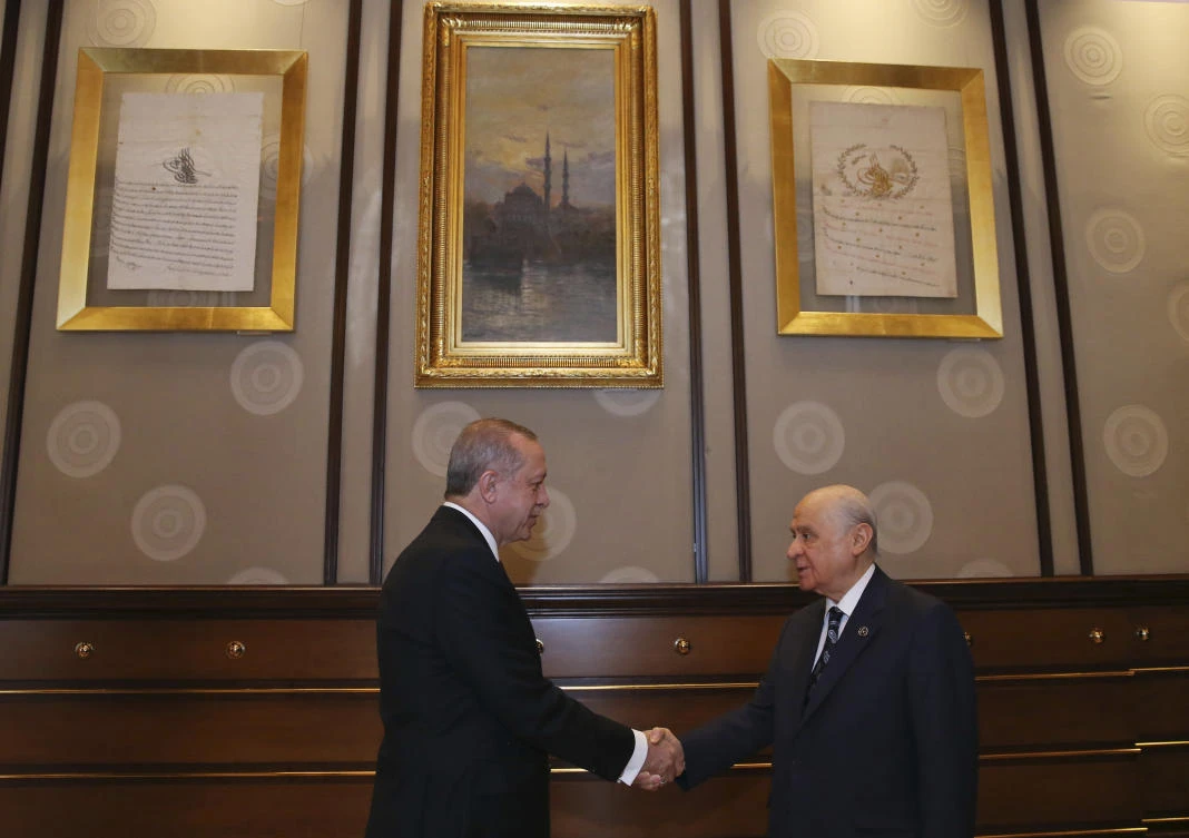 Turkey’s President Recep Tayyip Erdogan shakes hands with Devlet Bahceli, leader of the Nationalist Movement Party and his political ally, prior to their meeting, at the Presidential Palace, in Ankara, Turkey, where they called for general election in June, April 18, 2018. (AP)