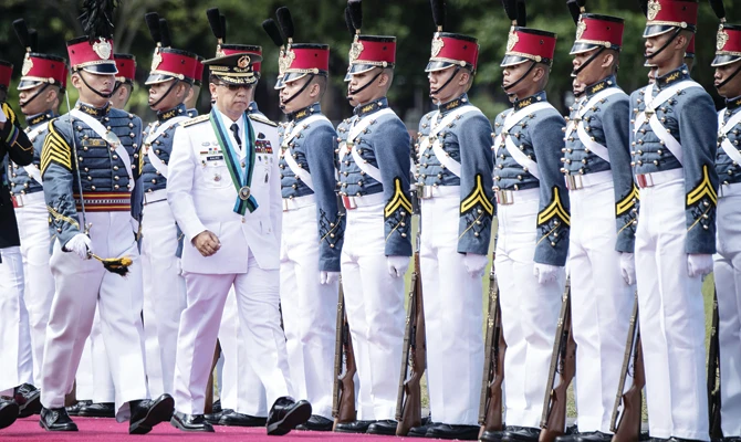New AFP Chief of Staff Carlito Galvez, center, inspects the honor guard during the Armed Forces of the Philippines change of command ceremony at the military headquarters in Camp Aguinaldo in Manila on Wednesday. (AFP)