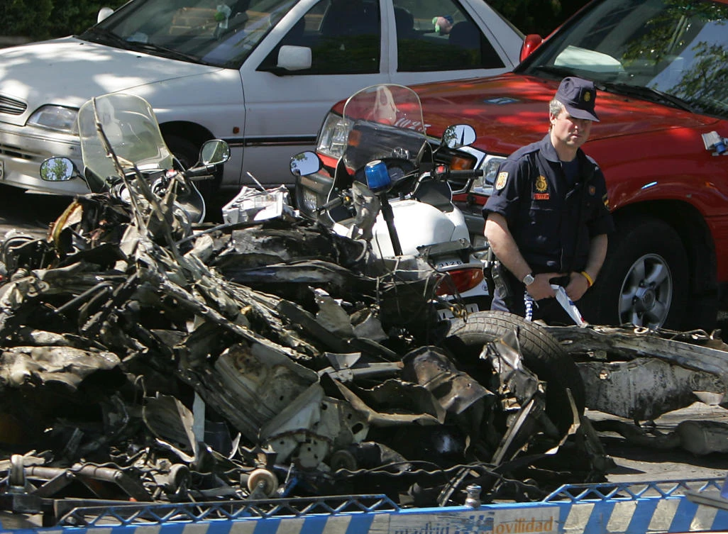 A car, in which a bomb planted by the Basque separatist group ETA exploded, is towed by police in Madrid in this 2005 photo. Police were able to evacuate the area before the bomb, which consisted of explosives stuffed inside two backpacks and placed inside a car believed to have been stolen a day earlier, went off. (AFP)