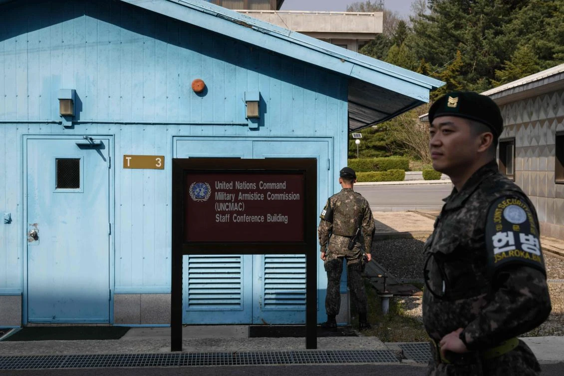 A South Korean soldier stands guard before a United Nations Command Military Armistice Commission meeting hut in the truce village of Panmunjom within the Demilitarized Zone that separates North and South Korea. (AFP)