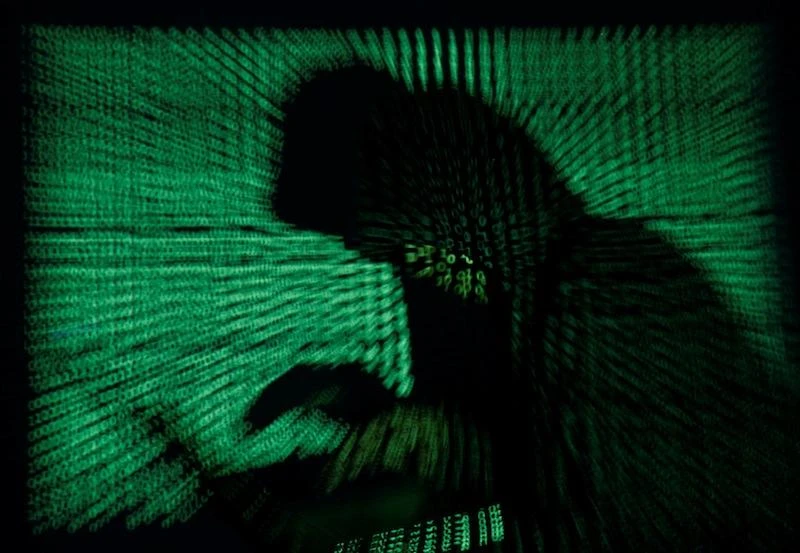 File photo showing a silhoutted view of a hacker qt work, as a UK teenager sentenced to two years in a youth detention center for compromising email, phone accounts of US government officials. (REUTERS)