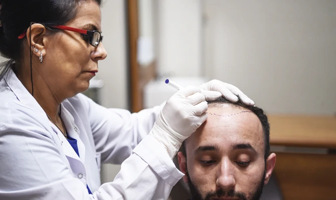A hair specialist checks a patient in Istanbul. (FIle/AFP)