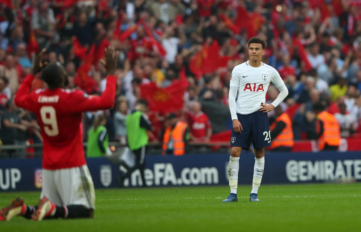 Joy for Manchester United's Romelu Lukaku is contrasted with the despair on the face of Tottenham's Dele Alli .