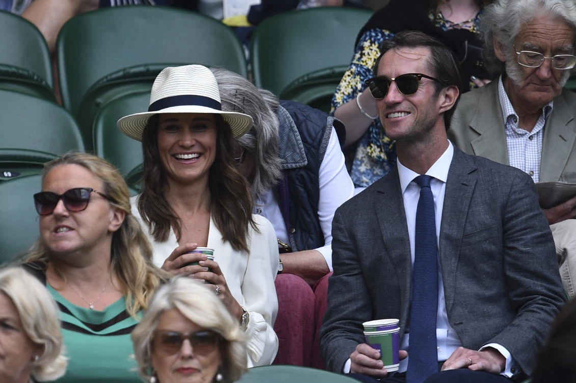 The file photo shows Pippa Middleton (L), sibling of Britain’s Catherine, Duchess of Cambridge, sits with her husband James Matthews ( R) (Glyn Kirk/AFP)
