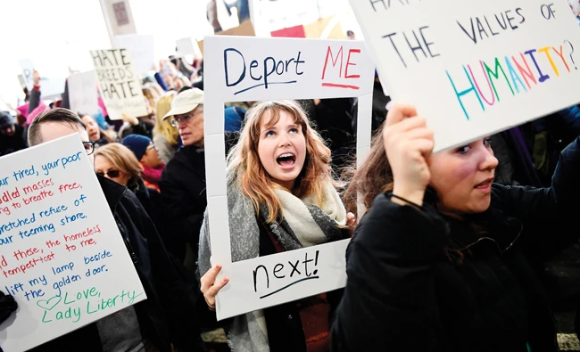 Madison Gray, a Temple University student, holds up a sign during a protest against President Donald Trump's executive order banning travel to the US by citizens of Iraq, Syria, Iran, Sudan, Libya, Somalia or Yemen. (AP)