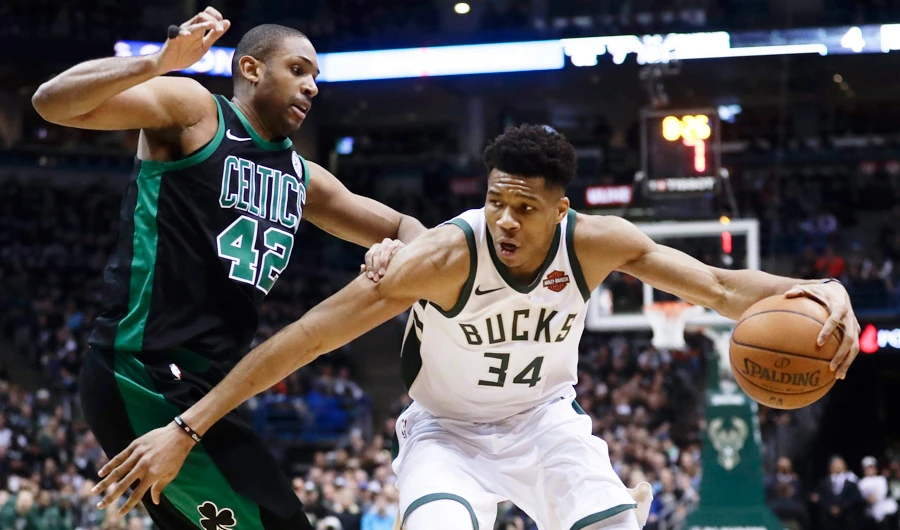 Milwaukee Bucks' Giannis Antetokounmpo tries to drive past Boston Celtics' Al Horford. (AP)