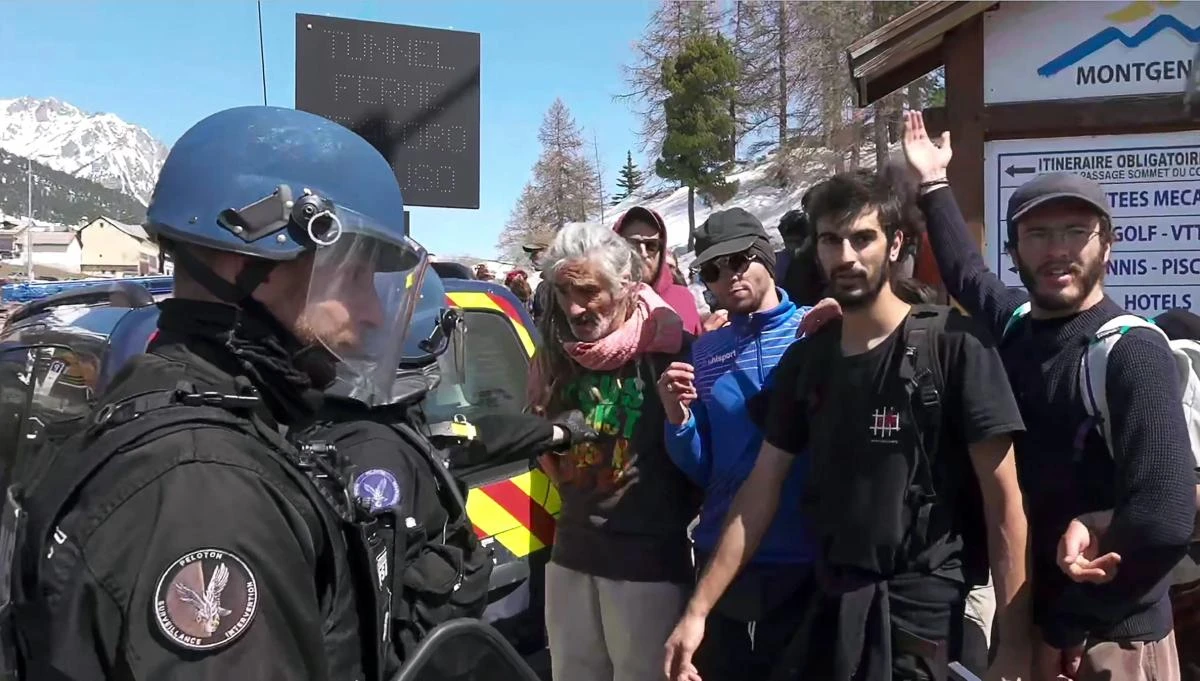 This video grab taken from a footage released and filmed by Italian news video platform Local Team on April 22, 2018, at Montgenevre on the border between France and Italy in the Alps, in the Alps, shows French gendarmes clashing with demonstrators taking part in a protest walk to help nearly 30 migrants to cross the border to France. (AFP)