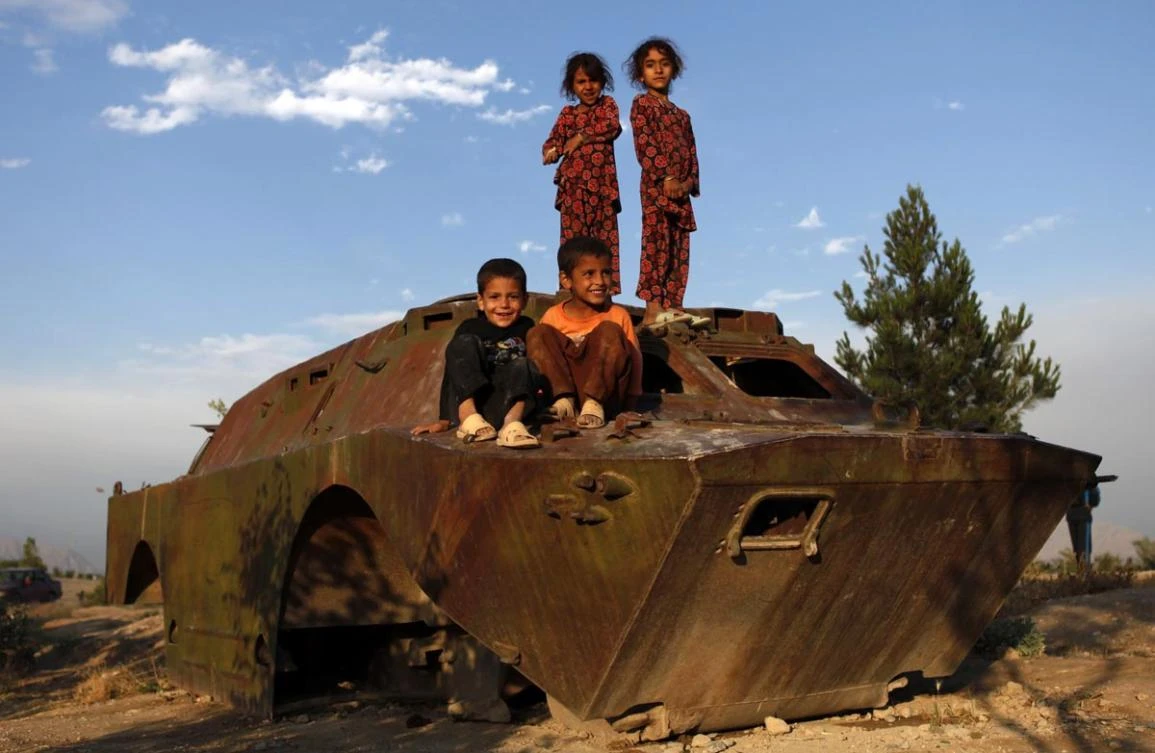 Afghan children play on an abandoned armored vehicle in Kabul. A lack of rain, in late 2017 and early this year, is leading to food insecurity and water scarcity that could worsen the already high malnutrition rates among children in Afghanistan. (Reuters)